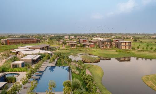 an aerial view of a resort with a pond at MYSA Zinc Journey by The Fern, Nani Devati in Sānand