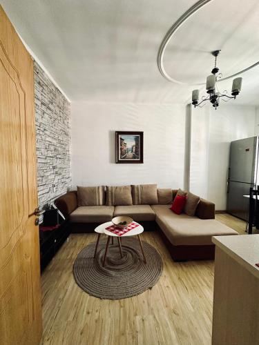 uma sala de estar com um sofá e uma mesa em SleepIn Shkoder em Shkodër