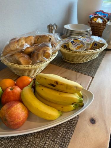 a plate of bananas and apples and baskets of bread at West Loch House in West Tarbert