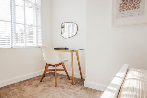 a desk in a bedroom with a chair and a bed at Principality View Apartment Two, by Solace Stays in Cardiff