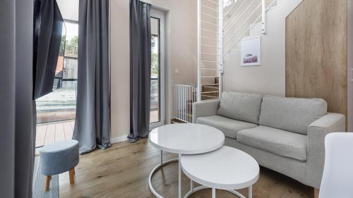 a living room with a couch and a table at Lighthouse, Sun & Snow in Mrzeżyno