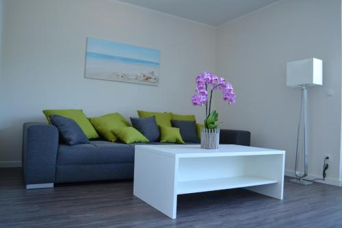 uma sala de estar com um sofá e uma mesa de café branca em Ostseeoase Kühlungsborn em Biendorf