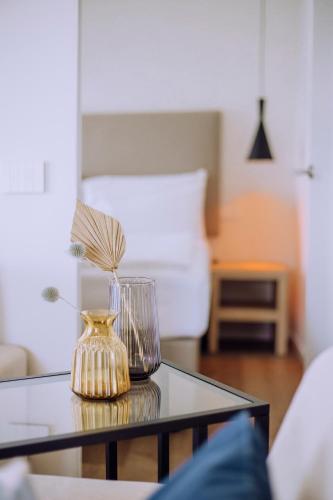 a glass vase sitting on a glass table at Ah Porticcioli Boutique Apartments in San Felice del Benaco