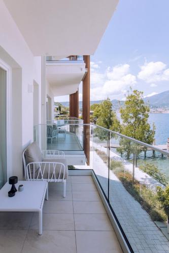 a house with a balcony with a view of the water at Ah Porticcioli Boutique Apartments in San Felice del Benaco