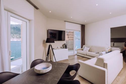 a living room with a table and a couch at Ah Porticcioli Boutique Apartments in San Felice del Benaco