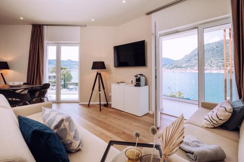 a living room with a view of the water at Ah Porticcioli Boutique Apartments in San Felice del Benaco