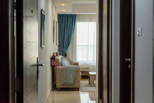 a room with a couch and a bed and a window at Mira Holiday Homes - Beautiful Studio in Living Legends in Dubai