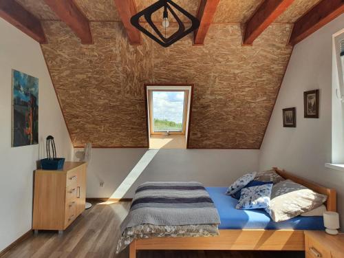 a bedroom with a blue bed and a window at Dom Porost in Porost