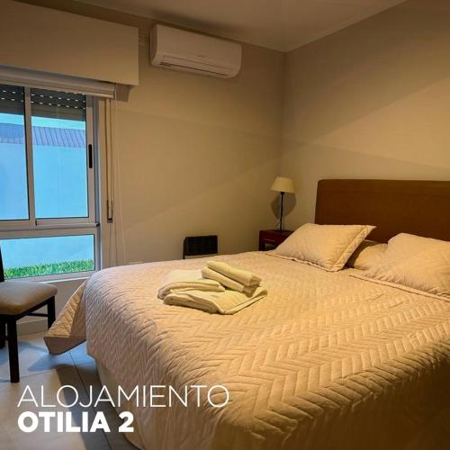 a bedroom with a bed with two towels on it at OTILIA 2 in Aldea Camarero