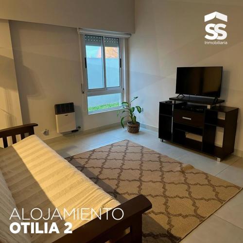 a living room with a bed and a tv at OTILIA 2 in Libertador San Martín