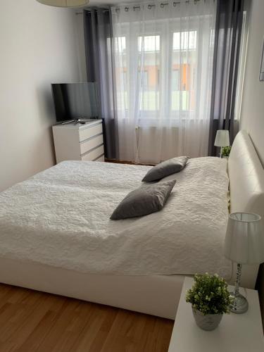 a bedroom with a bed with two pillows on it at Apartament Halina in Kołobrzeg