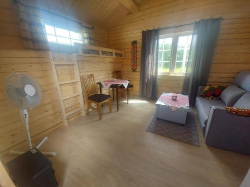 A seating area at small camping cabbin with bathroom near by