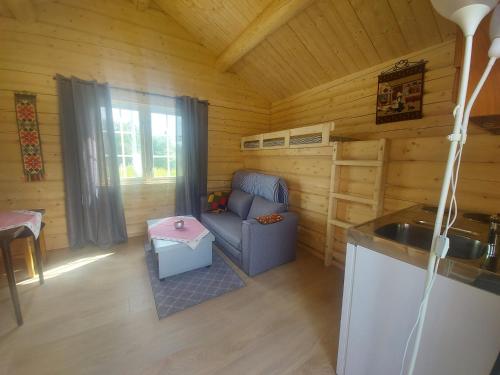 A seating area at small camping cabbin with bathroom near by