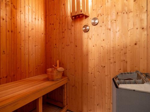 a bathroom with a wooden wall with a counter and a sink at Residenz "Zu den 3 Tannen" 4 in Zingst