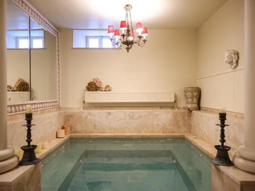a bathroom with a tub with a chandelier at 3BR Venetian-style Villa in Mytilene City Centre in Mytilini