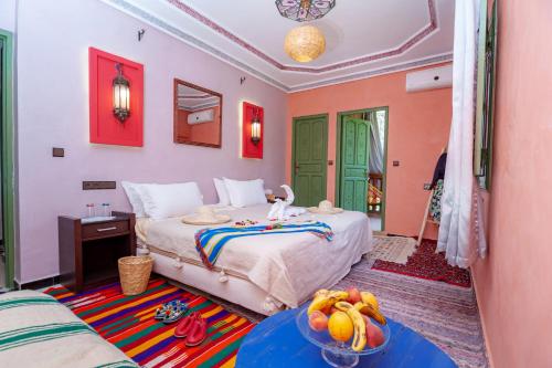 a bedroom with a bed and a bowl of fruit on a table at Smile House Imlil in Imlil