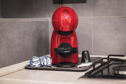 a red coffee maker sitting on top of a counter at [Centro Storico] Luxury Suites in Naples