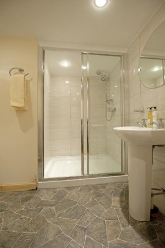 a bathroom with a shower and a sink at Clan Cottages Luxury Thatched Retreat near Oban in Oban