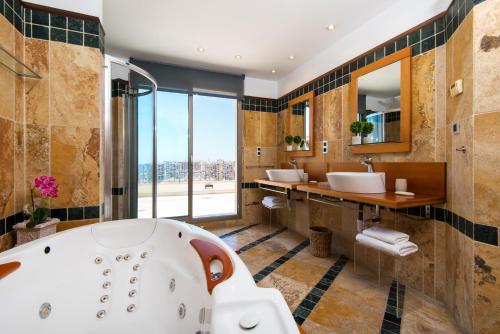 PH BELLAGIO: Luxurious and Romantic duplex penthouse with PRIVATE POOL & sea views في بينالمادينا: حمام مع حوض ومغسلة