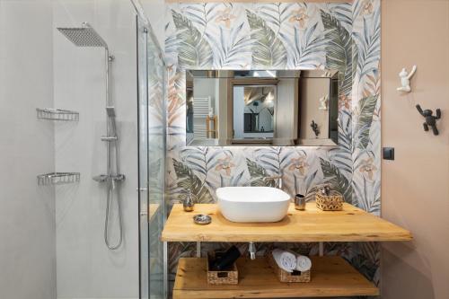 a bathroom with a sink and a shower at Villa Tolena in Pelekas