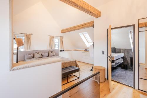 a bedroom with a bed and a mirror at Moxn Chalet Lungau - Authentic Luxury Living in Ramingstein