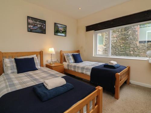 a bedroom with two beds and a window at Lynmouth View in Lynmouth