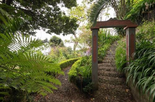 a pathway in a garden with a sign at Quinta Belmonte with Private Heated Pool in Funchal in Funchal
