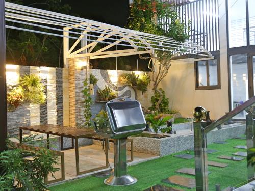 a small television sitting on a lawn in a garden at QV Manor Homestay in Phan Rang