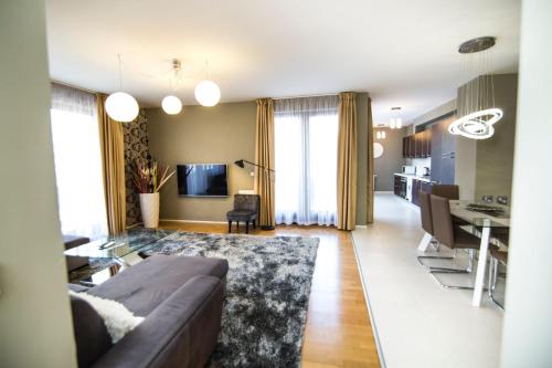 a living room with a couch and a dining room at Paulay free parking design 51 apartman with terazze in Budapest