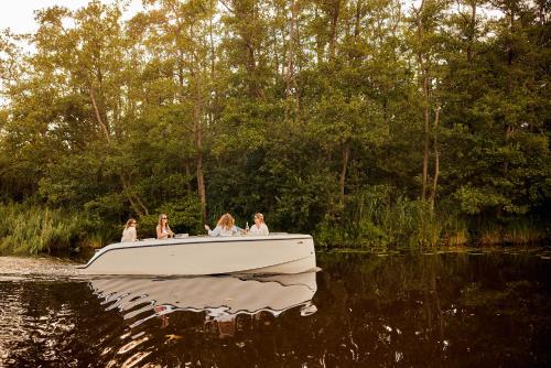 a group of people on a boat in the water at Dutchen Erfgoedpark De Hoop Glamping in Uitgeest