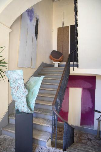a staircase in a building with a painting on the wall at Casa della Sofora in Bene Vagienna