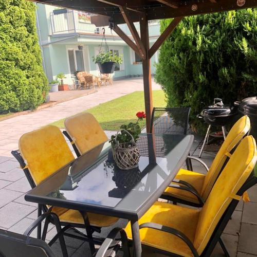 a table and chairs under an umbrella on a patio at Astoria Lednice in Lednice