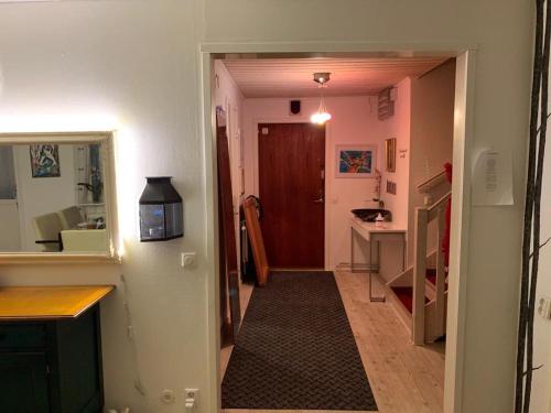 a hallway with a hallway leading to a kitchen with a door at Cozy private caravan on our lawn in Luleå