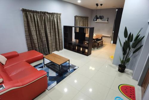 a living room with a red couch and a table at Akmal Homestay Klang in Klang