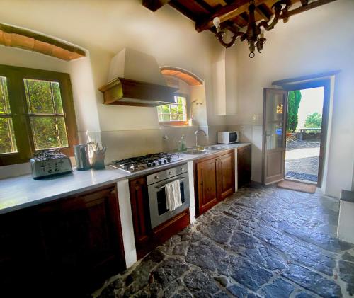 a kitchen with a stove and a counter top at Villa Rignana - Chianti Weddings in Greve in Chianti