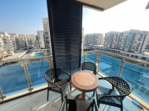 a balcony with a table and chairs and a view of a city at 2BD Apartment In New Alamein City شقة فندقية مدينة العلمين الجديدة in El Alamein