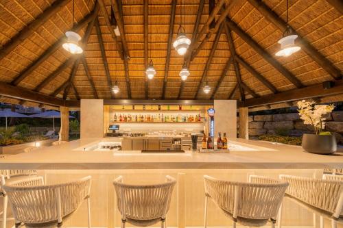 a lobby with chairs and a bar in a building at Eurostars Oasis Marbella in Marbella