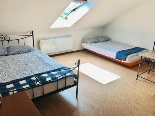 a attic bedroom with two beds and a skylight at Julus in Łeba
