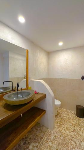a bathroom with a sink and a toilet at Serene Beach Villa in Gili Trawangan