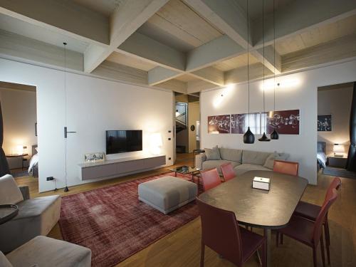 a living room with a table and a couch at EDIT Lofts in Turin