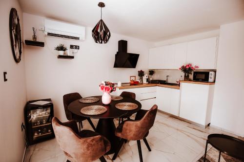 a kitchen with a table and chairs in a room at Holiday House Sunset Spa in Šentjernej