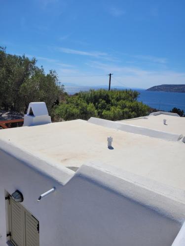 a white roof with a view of the ocean at Aegean traditional home in Athens Riviera in Sounio
