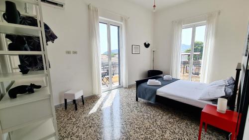 a bedroom with a bed and a window at Àrima Mondello Apartment in Mondello