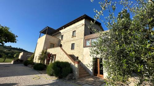 a large brick building with a windmill on top of it at Agriturismo nelle Marche in Montalto delle Marche