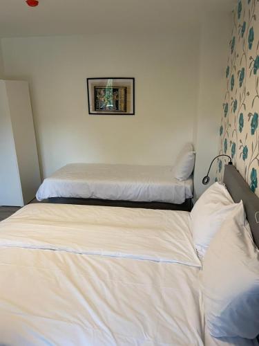 two beds in a room with two mattresses at Hotel B&B Sint-Maria NEXT DOOR in Valkenburg