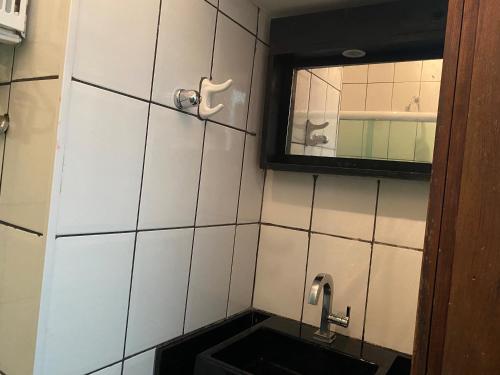 a bathroom with a sink and a mirror at Santana Temporada - Bolivar Apartments in Rio de Janeiro