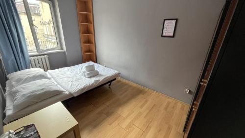 a small room with a bed and a window at roomspoznan pl - Rybaki 15 - 24h self check-in in Poznań