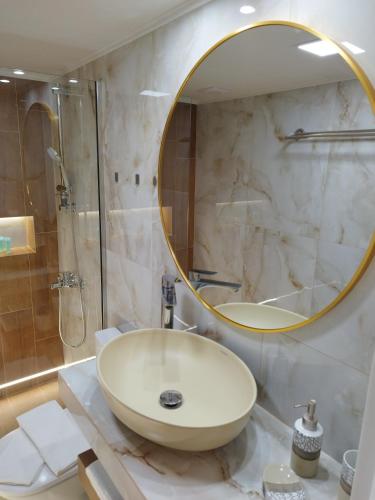 a bathroom with a sink and a mirror at AEGEAN SUITES in Keramotí