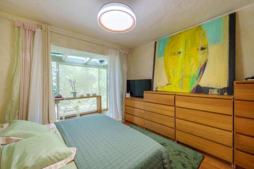 a bedroom with a bed and a tv and a window at Villa Smeralda in Porto Rotondo