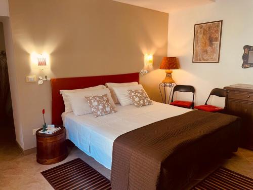 a bedroom with a large bed with two pillows at Le Terrazze Sul Pollino B&B in Civita
